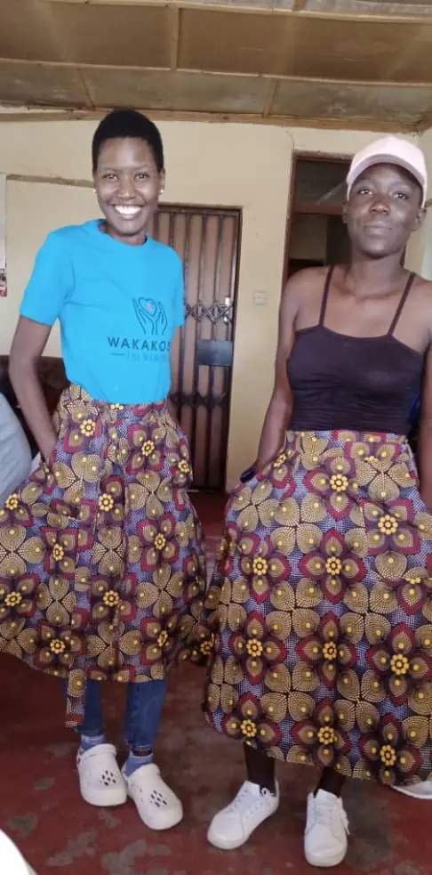 Two young women showing skirts they made themselves